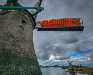 Windmills in Zaanse Schans in the Netherlands with reflections over the water