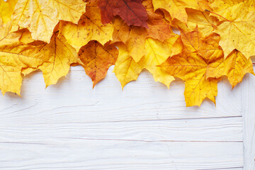 Naklejka na ściany i meble Autumn Leaves over wooden background. Autumn leaves frame