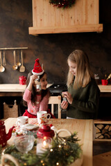 Children are making cookies under the Christmas tree