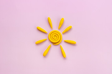 Weather forecast concept with plasticine sun, top view