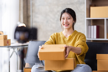 Entrepreneur business Asian woman working online SME e-commerce seller at home, Asian woman seller prepare parcel box of product for deliver to customer. Startup Small Business online selling SME idea