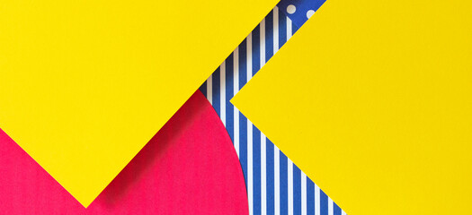 Texture background of fashion papers in memphis geometry style. Yellow, blue, pink, white colors, striped and polka dot pattern. Top view, flat lay