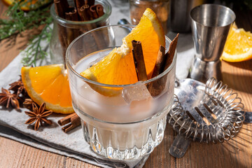 Autumn alcohol drink, boozy refreshing milk and honey cocktail with benedictine orange and cinnamon...