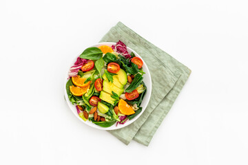 Top view of served green salad with avocado and tomatoes