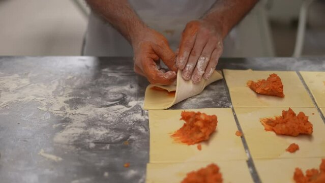 artisan bakery, baker making bread and pastry, dough kneading, to assemble savory pastries