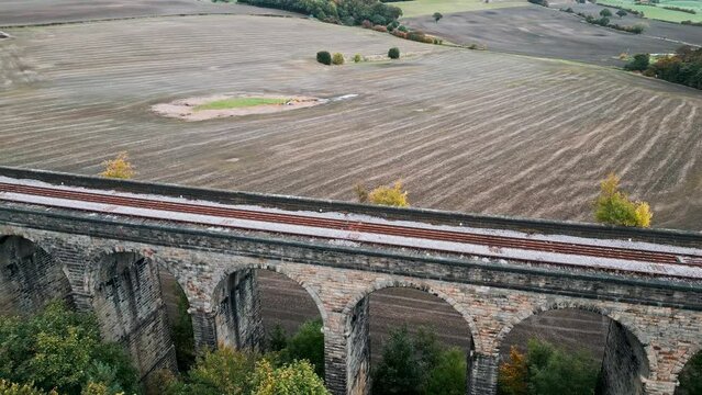 Aerial footage of the Penistone Viaduct a curved railway viaduct which carries the Railway over Sheffield Road and the River Don.