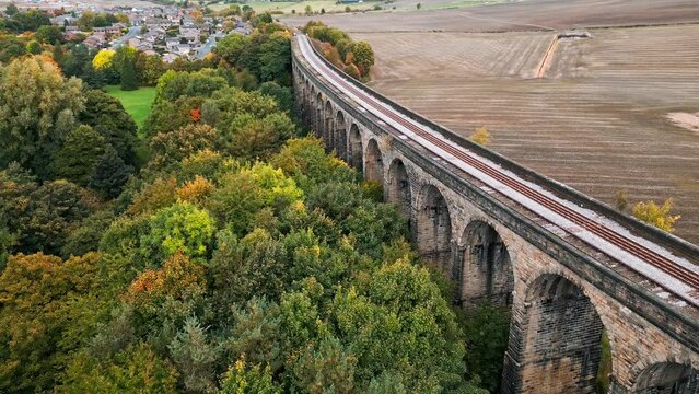 Drone aerial footage of the Penistone Viaduct a curved railway viaduct which carries the Railway over Sheffield Road and the River Don.