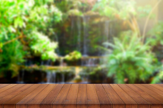 wooden table top on blurred park background