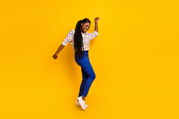 Fototapeta na wymiar Full length body size view of attractive cheerful lucky girl dancing having fun isolated over bright yellow color background