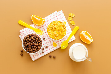 Kids morning with corn flakes milk and orange for breakfast