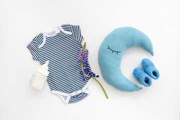Baby cotton bodysuit with bottle of milk and toys