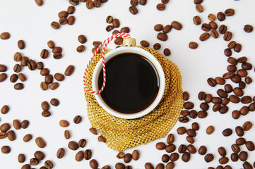 Christmas New Year coffee concept. Cup of black espresso coffee decorated as christmas tree ball on white background with scattered coffee beans