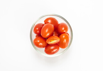 red cherry tomato stack isolated on white background.  small tomato in glass bowl. healthy vegetables.