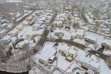 American town with small number of house complexes with snow covering the roofs during a snowstorm the winter season in New Jersey