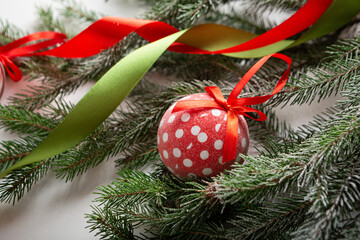 Close up of Christmas polka dots red ball  and green branches holiday concept