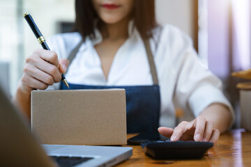 young woman work in back office for checking the product in the warehouse, concept e commerce.