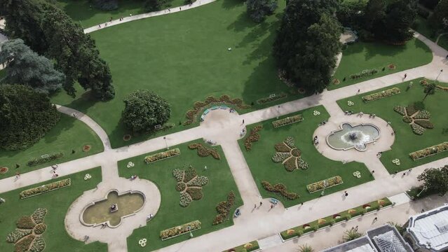 Thabor gardens with fountains and flower beds at Rennes in France. Aerial top-down sideways