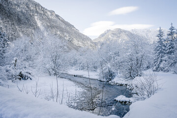 Fototapeta na wymiar snowy winter landscape crossed by a river 