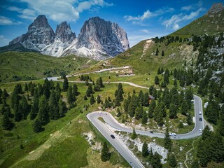 Aerial view of curving roads at Sella Pass in the Dolomites Mountain in Italy - obrazy, fototapety, plakaty