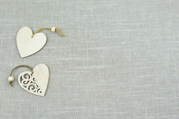 Heart made of wood on a gray background. Beige texture background. Natural cotton burlap.