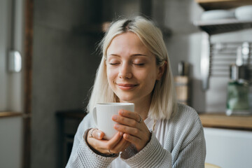 woman smelling coffee. morning coffee in kitchen