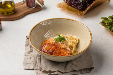 Portion of gourmet fettuccine pasta with grilled chicken breast