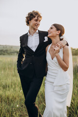 Young wedding couple together in field