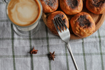 Cake with coffee in a glass on a white checkered towel