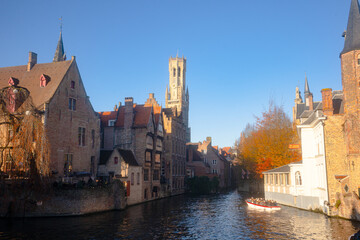 Fototapeta premium Rozenhoedkaai in Brugge , panoramic view along the canal and medieval buildings in old town during winter sunny day : Brugge , Belgium : November 30 , 2019