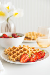 Belgian waffles with strawberry on white plate. Breakfast food concept