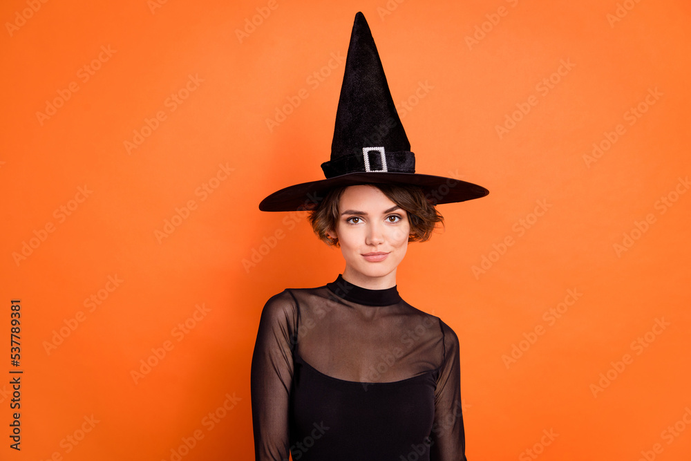 Wall mural Photo of funny adorable lady wear black witch dress cap smiling isolated orange color background - Wall murals