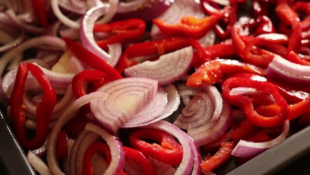 seasoning red bell peppers end red onion ready for roasting