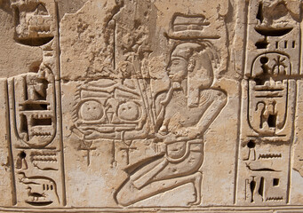 Hieroglyphic carvings on an ancient egyptian temple wall