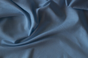 Abstract crumpled linen fabric texture background. Natural blue color dyed linen organic eco textiles canvas background. Top view