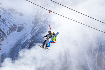 People are lifting on open lft high up in Caucasus mountains