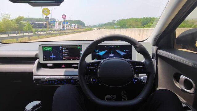 Young man driving with autopilot mode