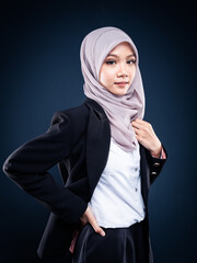 Naklejka premium Portrait of Muslim woman in office attire and wearing a hijab. Asian woman in a corporate world. Formal corporate outfit and elegant appearance. Corporate or business people concept. Isolated