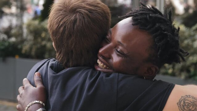Stop racism: African American man and Caucasian man hug each other