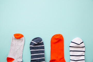 Odd socks day. Mismatch socks at blue background. Top view layout with copy space.