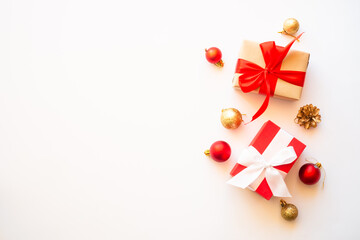 Christmas present boxes with holiday decorations at white background. Flat lay composition.