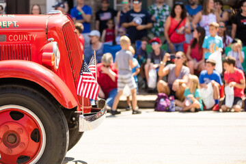 Small Town Fourth of July Parade, Vintage Firetruck with American Flags - obrazy, fototapety, plakaty
