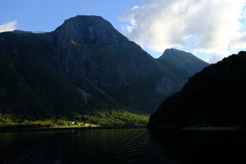 Naklejka na ściany i meble lake and mountains, village in a spot of light