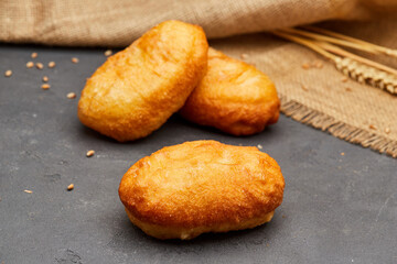 Tasty fried donuts on dark stone background. Unhealthy food. Studio shoot