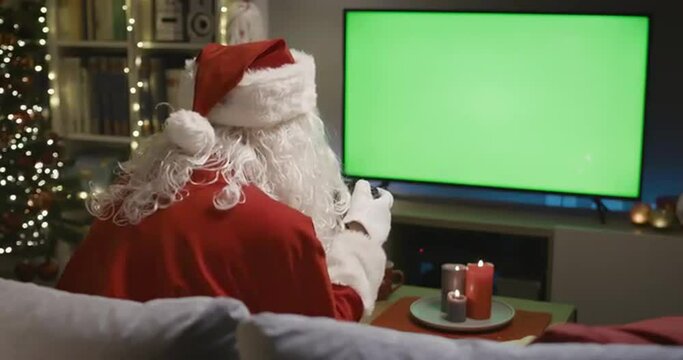 Happy Santa Claus playing video games