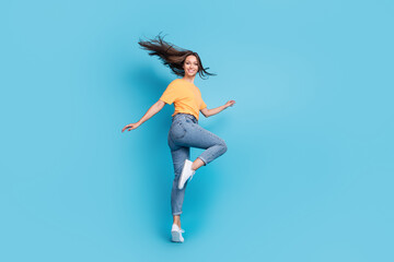 Full length photo of pretty sweet girl dressed yellow t-shirt dancing isolated blue color background