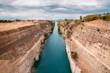 Corinth canal in Greece that connects the Gulf of Corinth in the Ionian Sea with the Saronic Gulf in the Aegean Sea - obrazy, fototapety, plakaty