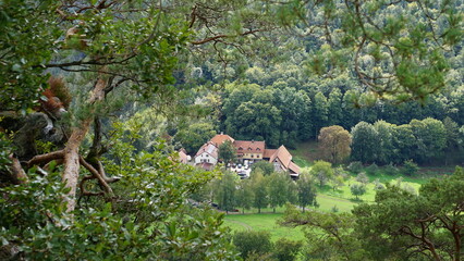 the view of the Gimbelhof in Lembach from the rock Rocher Krappenfels in the Northern Vosges in the Departement Haut-Rhin of the region Grand Est Alsace in France in the month of September 2022