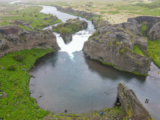 Naklejka na ściany i meble Drone view at Hjalparfoss waterfall in Iceland