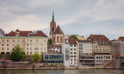 Fototapeta na wymiar Buildings in the city centre of Basel and the Rhine river, Switzerland. Riverside of swiss city