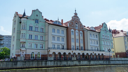 Obraz premium Residential multi-storey buildings in Fishing village, Kaliningrad, Russia. Embankment of Pregolya River. Views of city and streets of Kaliningrad